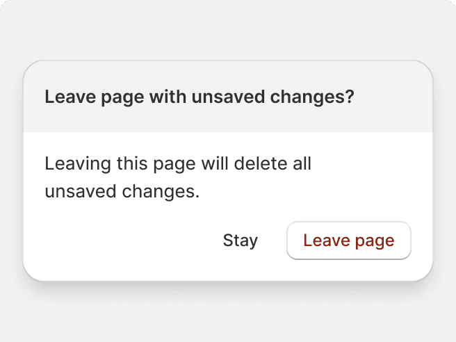 A modal with a gray header and white button with red text that stops the user from navigating away from a page with unsaved changes